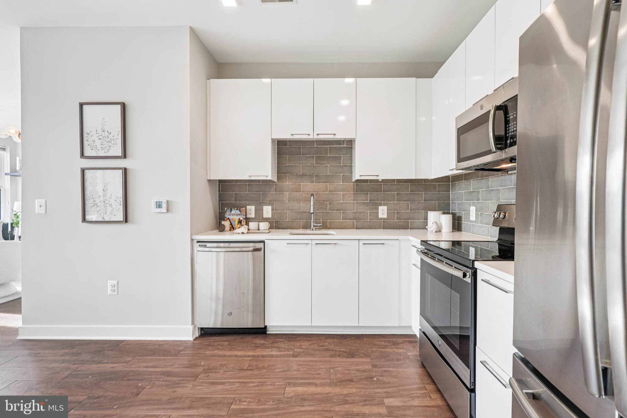 989 South Buchanan Street, Unit 225 Arlington, VA 22204 - Photo 11 of 42 a kitchen with stainless steel appliances granite countertop a stove top oven a sink and dishwasher