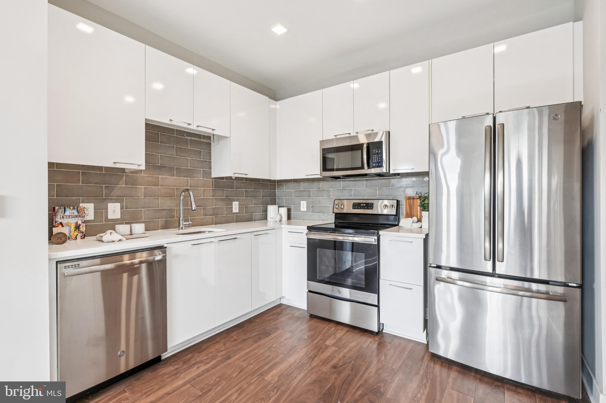 989 South Buchanan Street, Unit 225 Arlington, VA 22204 - Photo 12 of 42 a kitchen with stainless steel appliances a refrigerator sink and microwave