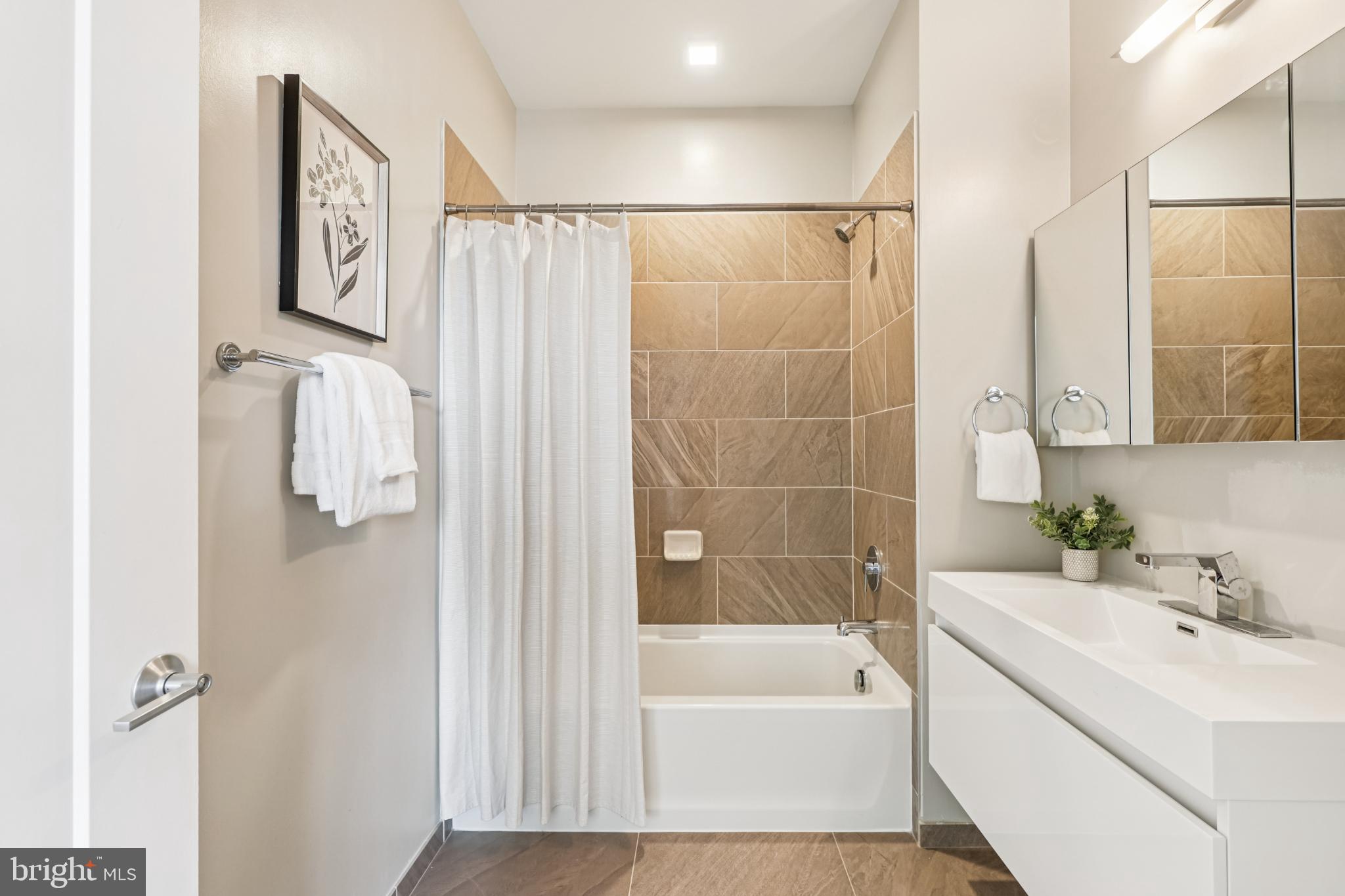 989 South Buchanan Street, Unit 225 Arlington, VA 22204 - Photo 20 of 42 a bathroom with a tub a sink and a shower
