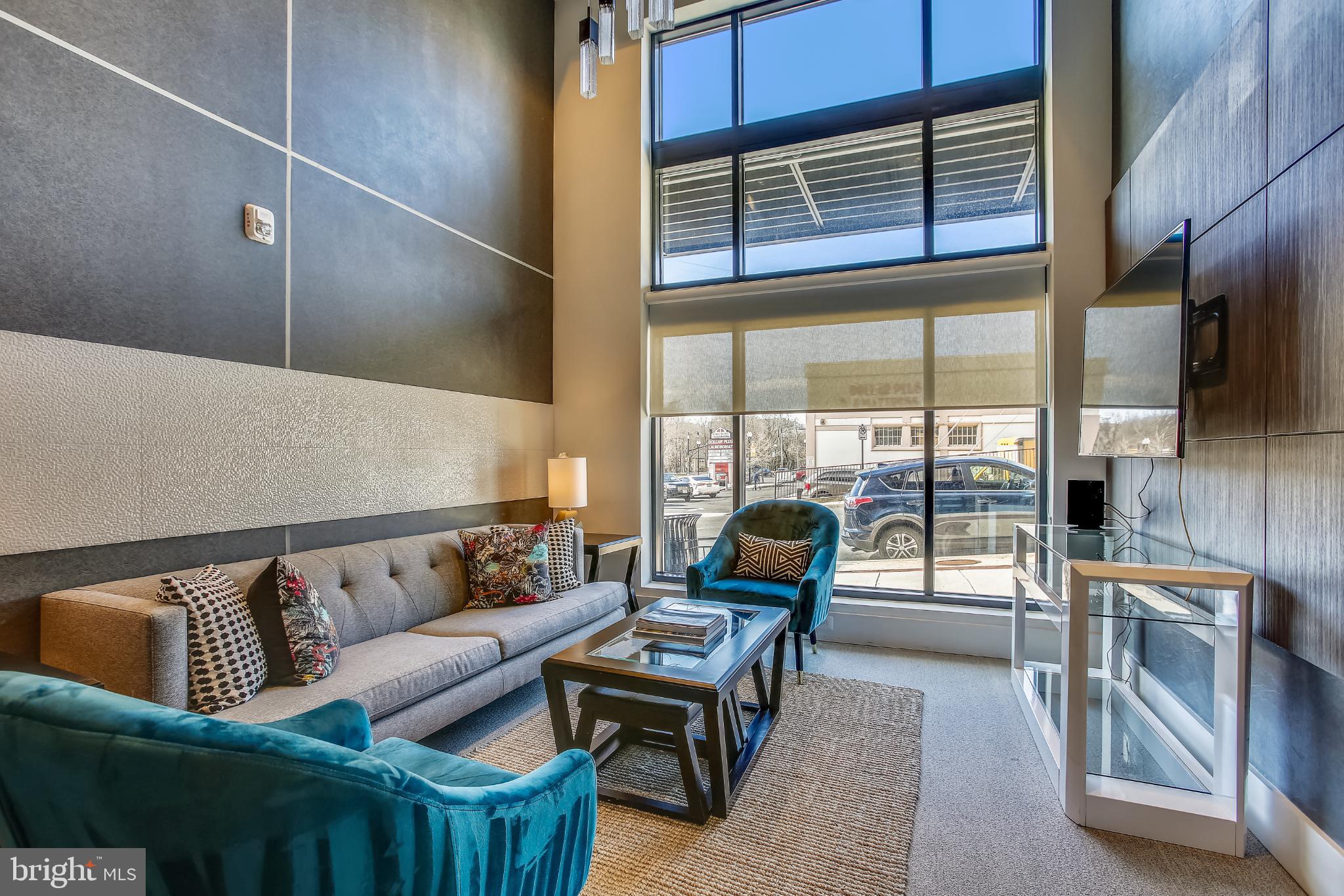 989 South Buchanan Street, Unit 225 Arlington, VA 22204 - Photo 36 of 42 a living room with furniture and a floor to ceiling window