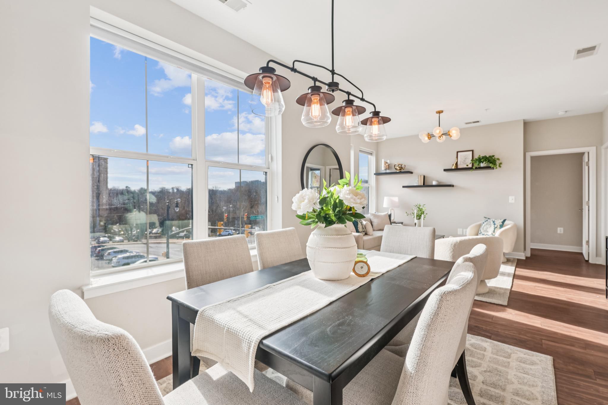 989 South Buchanan Street, Unit 225 Arlington, VA 22204 - Photo 7 of 42 a view of a dining room with furniture large windows and wooden floor