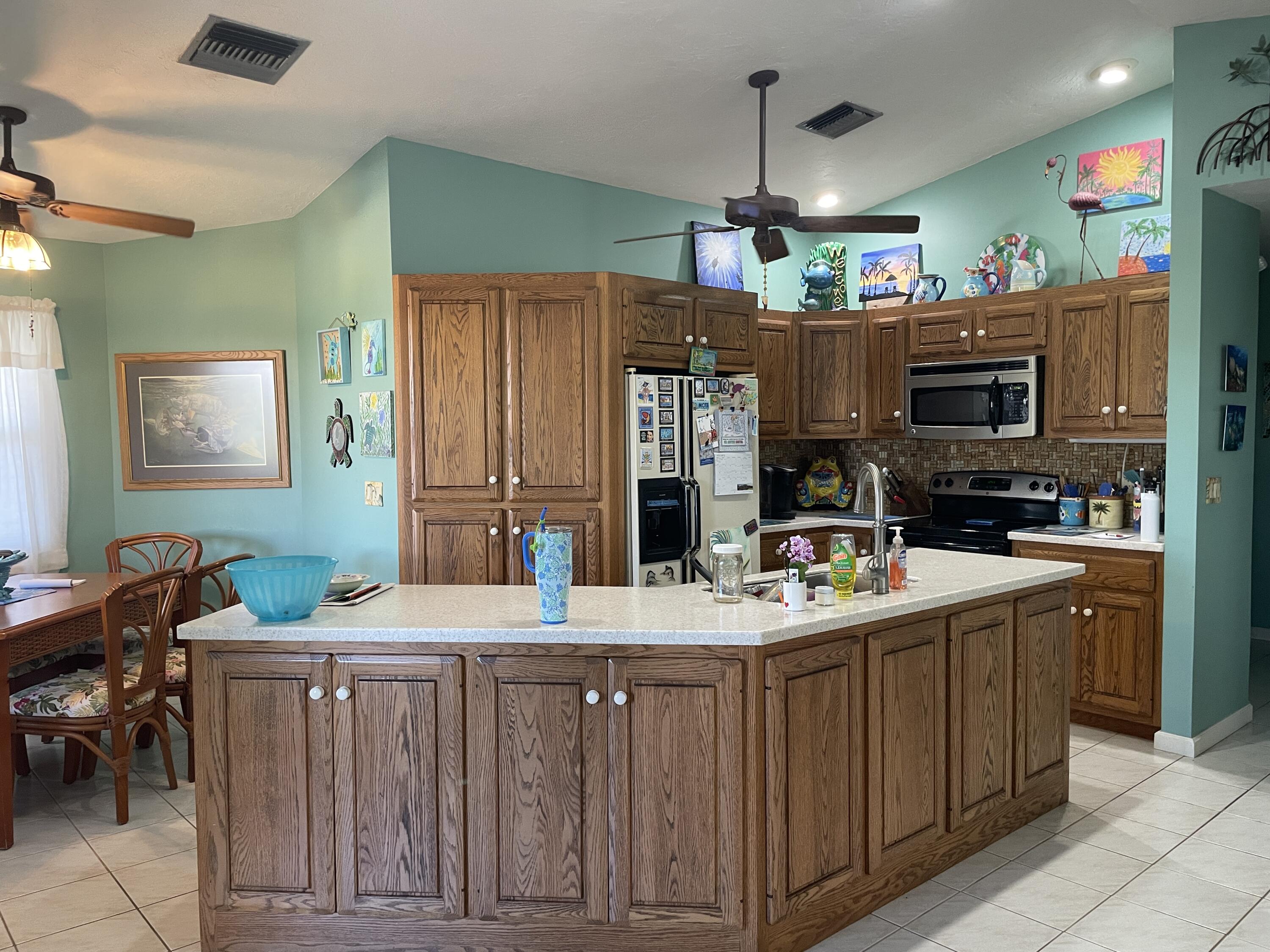 22979 Sharp Lane Cudjoe, FL 33042 - Photo 11 of 18 a kitchen with a sink stove and refrigerator