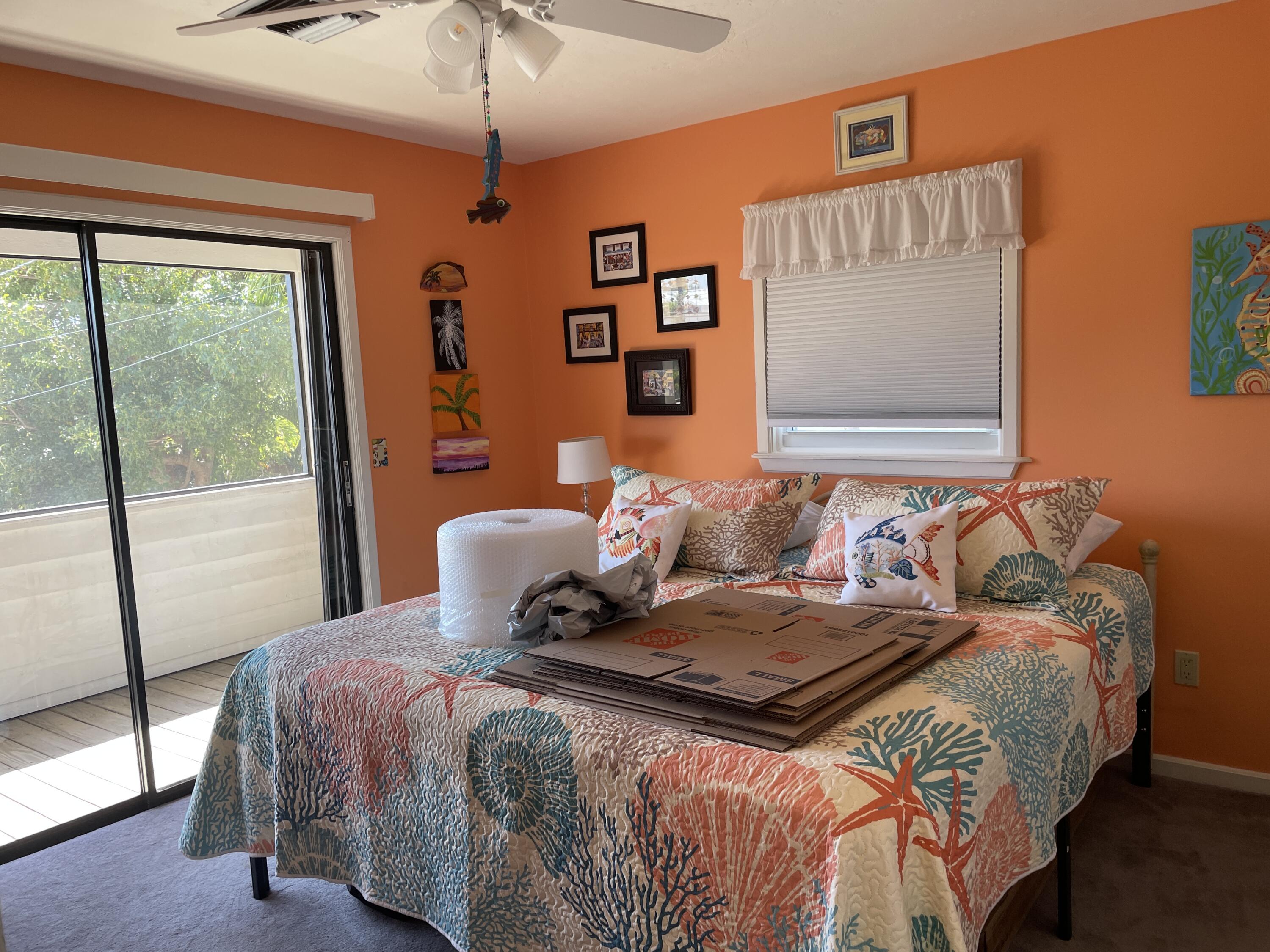 22979 Sharp Lane Cudjoe, FL 33042 - Photo 14 of 18 a bedroom with a large bed and a window