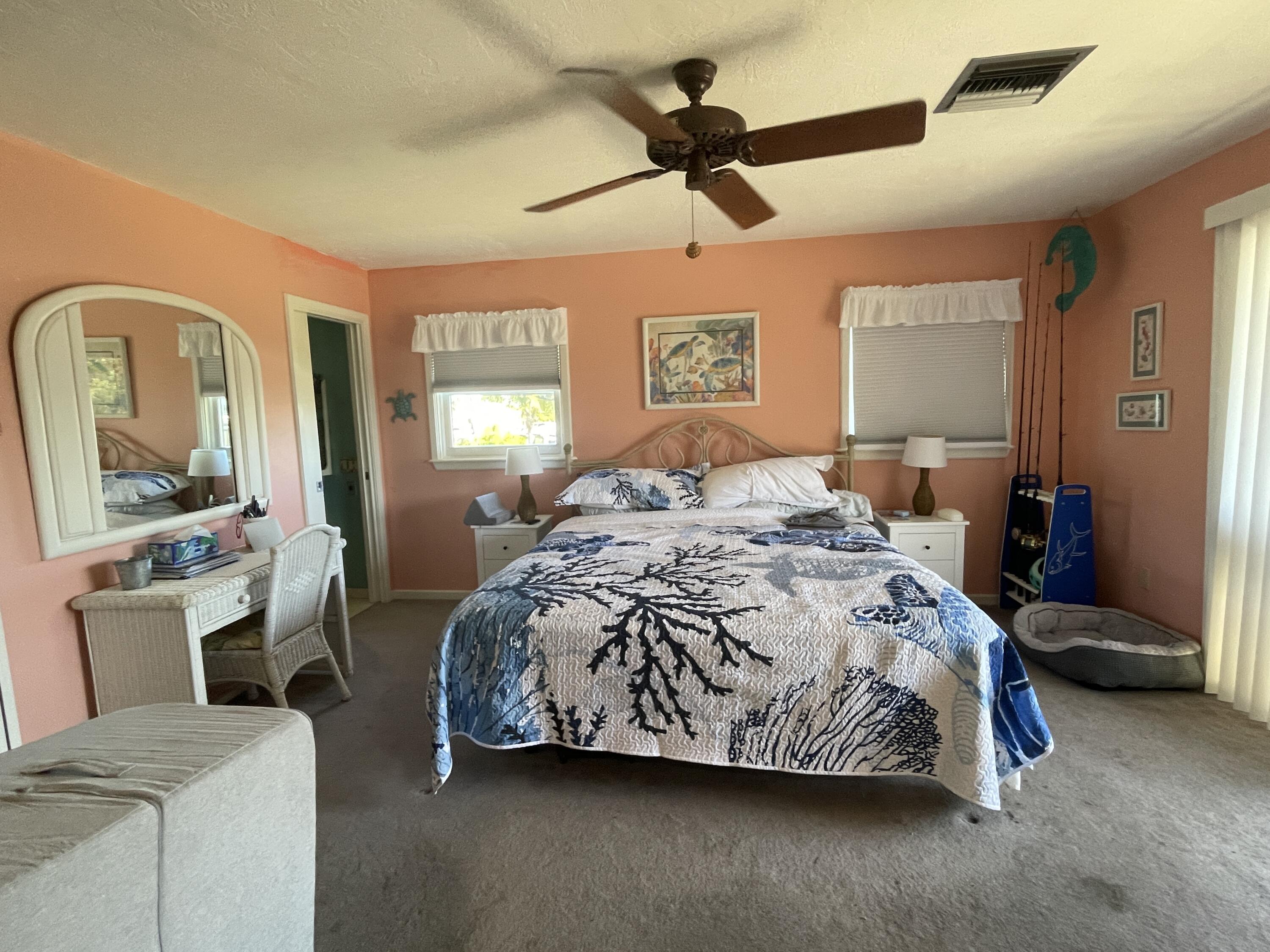22979 Sharp Lane Cudjoe, FL 33042 - Photo 15 of 18 a bedroom with a bed and wooden floor