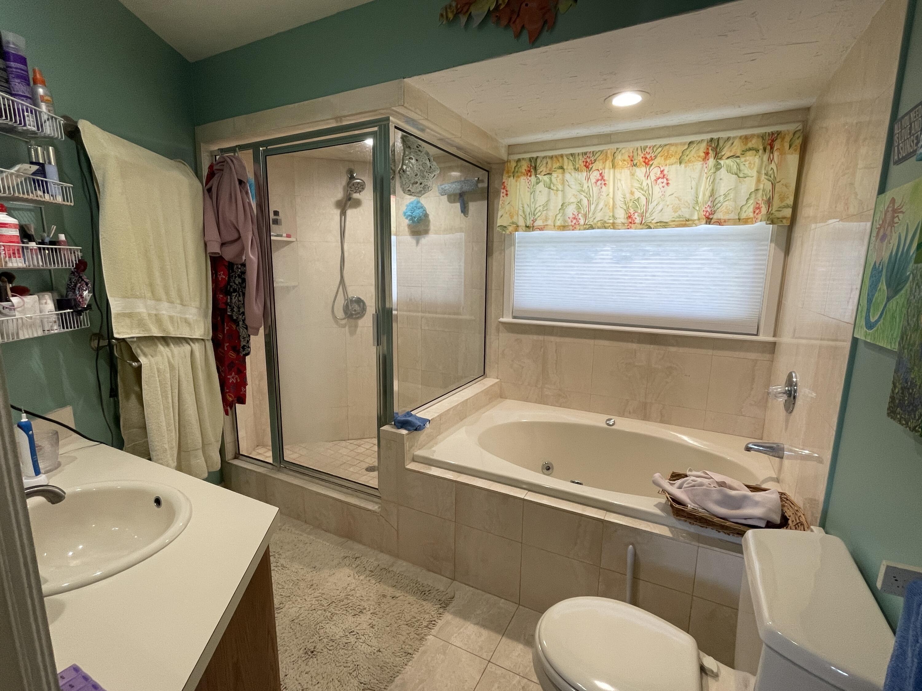 22979 Sharp Lane Cudjoe, FL 33042 - Photo 16 of 18 a bathroom with a sink a toilet and a shower