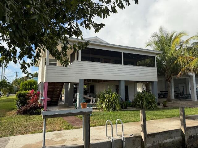 22979 Sharp Lane Cudjoe, FL 33042 - Photo 3 of 18 a front view of house with deck and yard