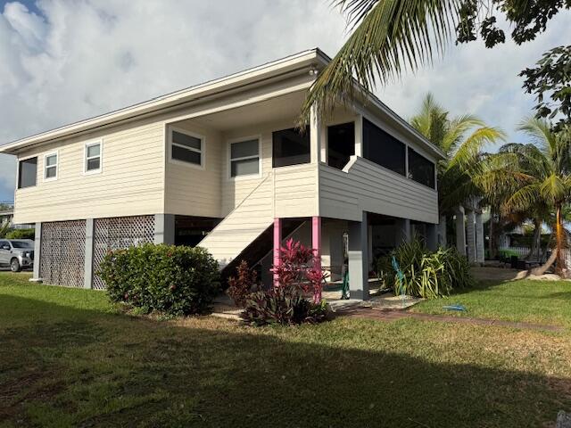 22979 Sharp Lane Cudjoe, FL 33042 - Photo 4 of 18 a front view of a house with garden