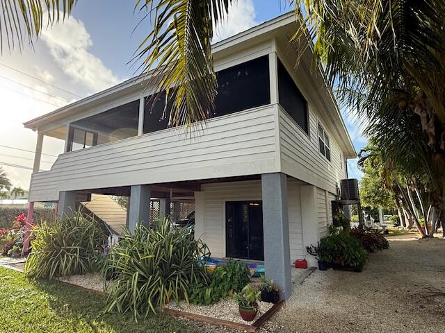 22979 Sharp Lane Cudjoe, FL 33042 - Photo 6 of 18 a view of a house with a yard and plants