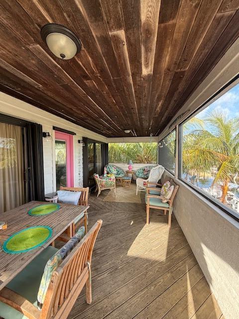 22979 Sharp Lane Cudjoe, FL 33042 - Photo 8 of 18 a view of a patio with table and chairs and wooden floor