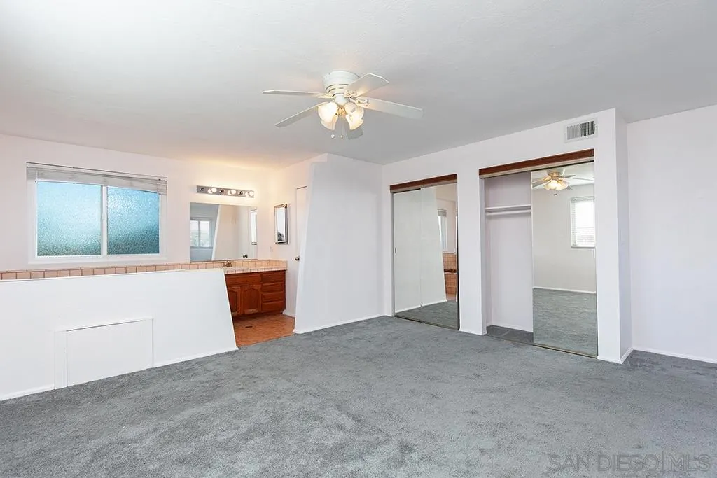 10941 Del Rio Road Spring Valley, CA 91978 - Photo 11 of 19 a view of a livingroom with a chandelier fan and a kitchen