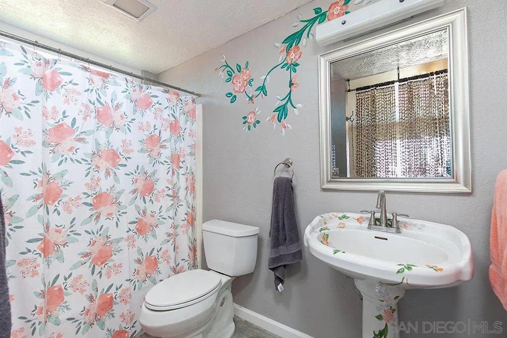 10941 Del Rio Road Spring Valley, CA 91978 - Photo 14 of 19 a bathroom with a sink toilet and a mirror