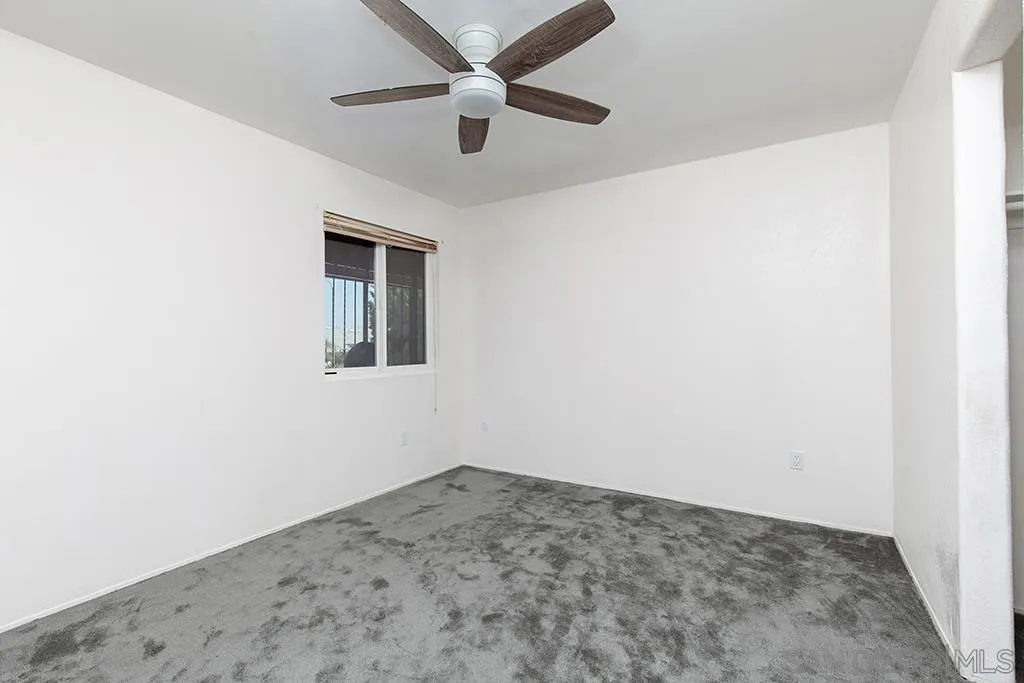 10941 Del Rio Road Spring Valley, CA 91978 - Photo 15 of 19 an empty room with a window and a fan