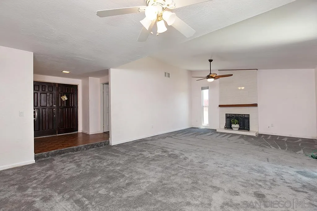 10941 Del Rio Road Spring Valley, CA 91978 - Photo 3 of 19 an empty room with fan and entrance door