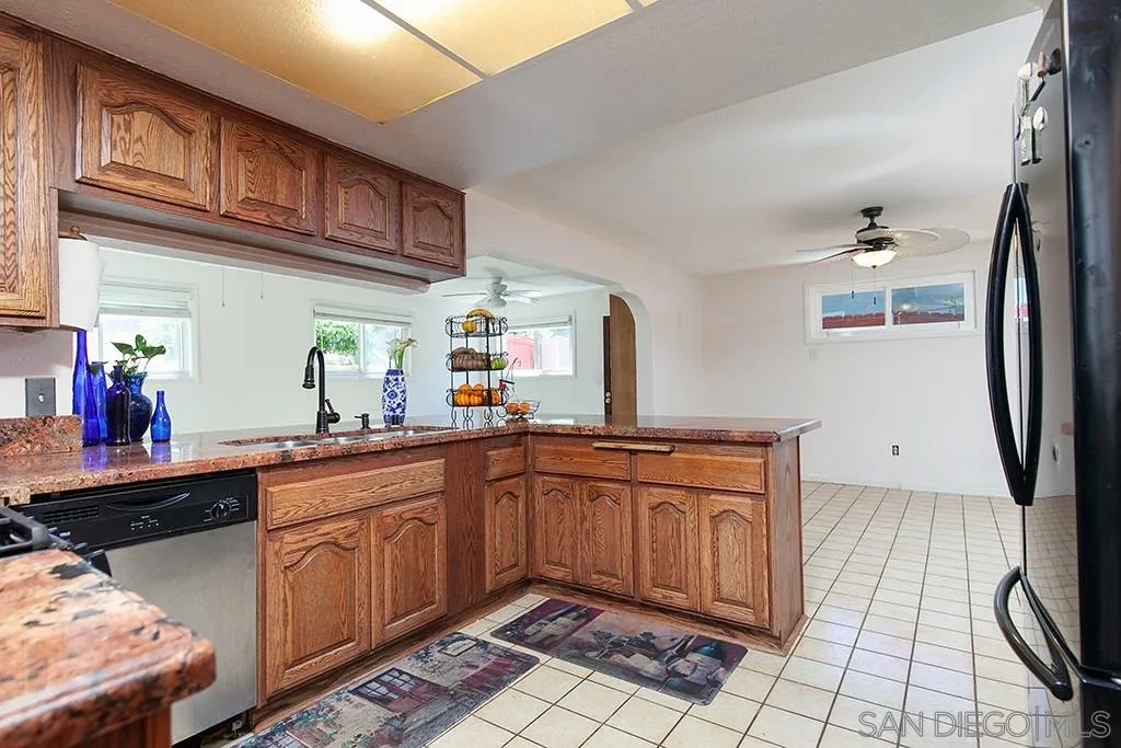 10941 Del Rio Road Spring Valley, CA 91978 - Photo 5 of 19 a kitchen with stainless steel appliances granite countertop a sink and cabinets