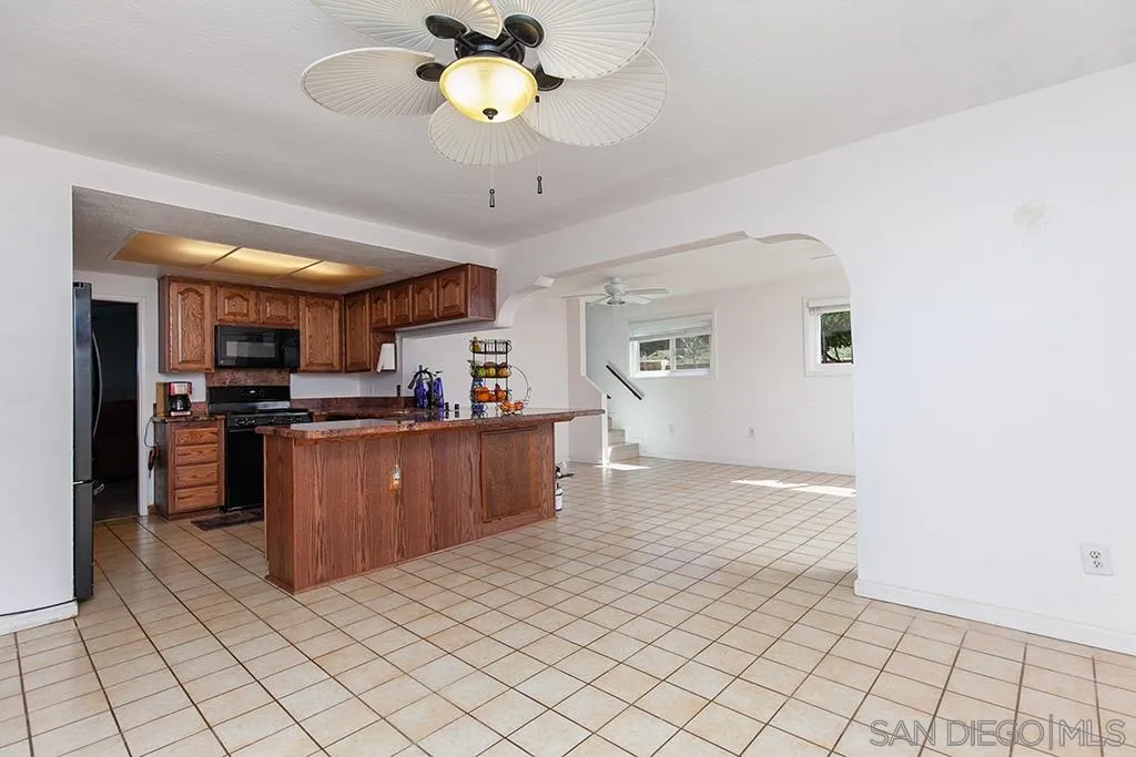 10941 Del Rio Road Spring Valley, CA 91978 - Photo 6 of 19 a view of kitchen with stainless steel appliances cabinets and outdoor space