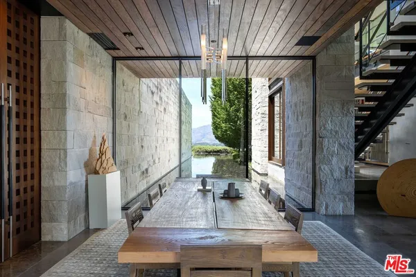 a living room with furniture and large windows