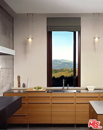 a kitchen with sink and view of living room