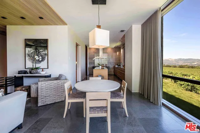 a view of living room with furniture and large window