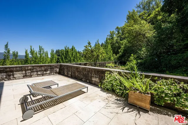 a view of living room with furniture and large window