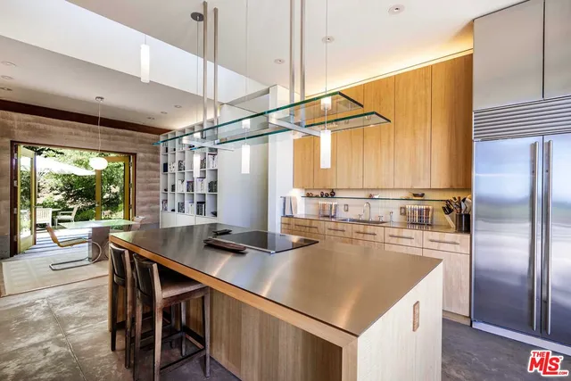 a view of a kitchen with stainless steel appliances granite countertop a stove and a refrigerator