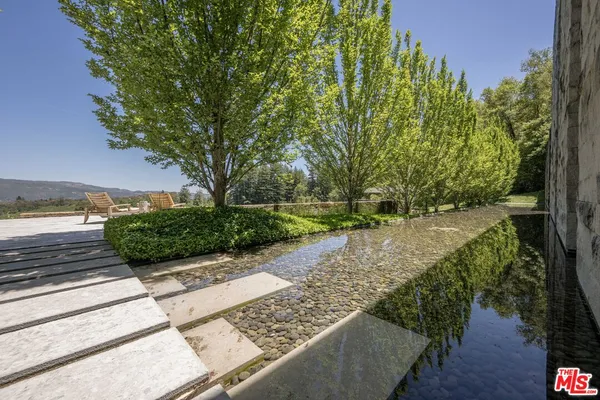 a room with wooden floor table and chairs