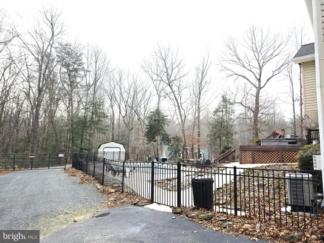 a kitchen with stainless steel appliances granite countertop a refrigerator a stove and a sink with granite countertops