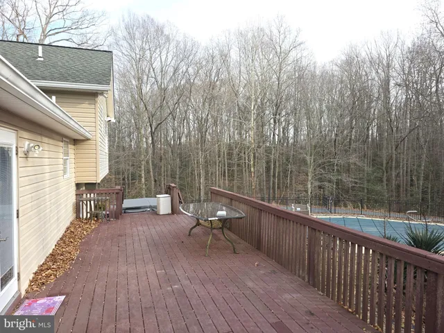 an empty room with wooden floor closet and windows