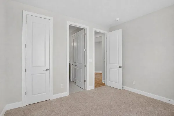 a view of an empty room and closet area