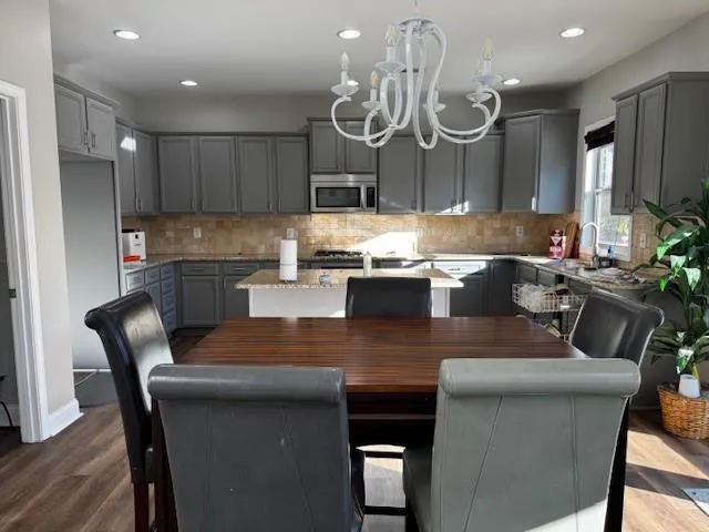 a large kitchen with a table and chairs