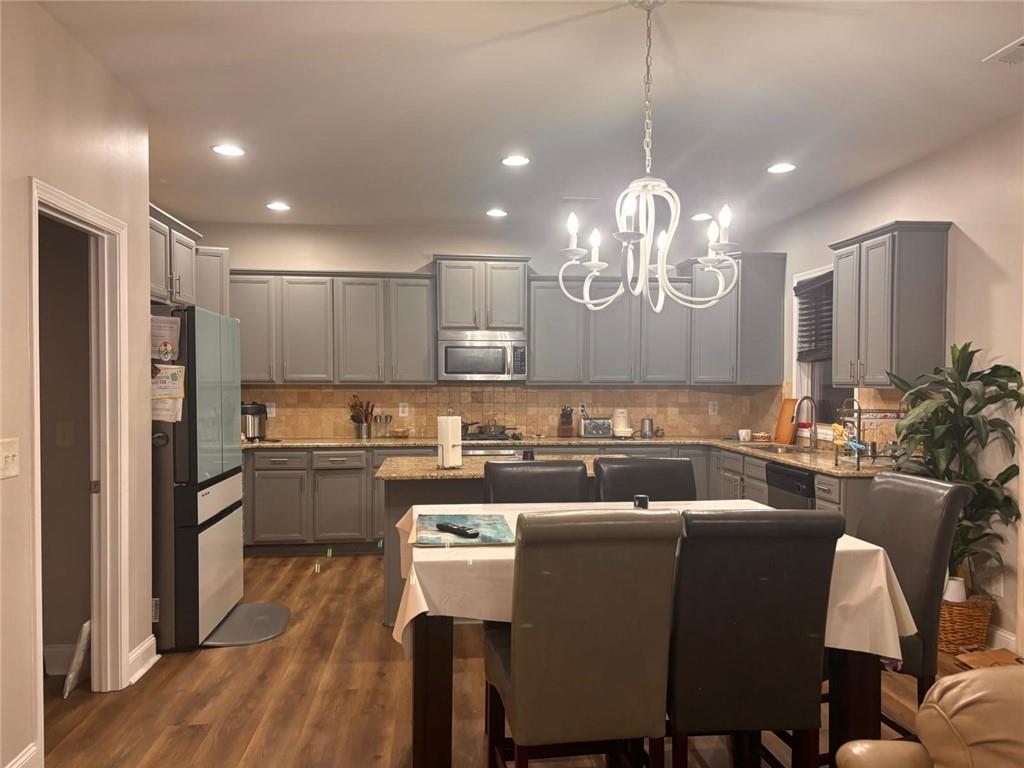 1440 A Waverly Glen Drive Alpharetta, GA 30004 - Photo 13 of 28 a kitchen with a table chairs refrigerator and microwave