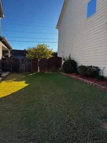 a view of a swimming pool with a yard