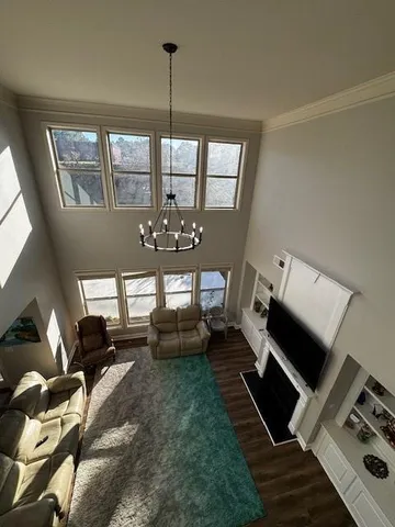 a living room with furniture and a chandelier