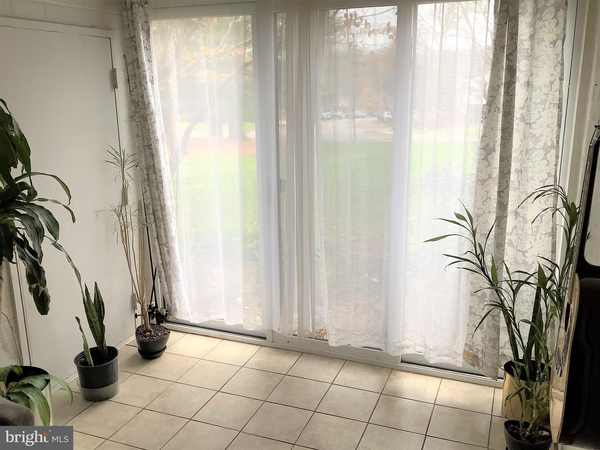 10578 Cross Fox Lane, Unit A1 Columbia, MD 21044 - Photo 5 of 15 Sunroom with slider
