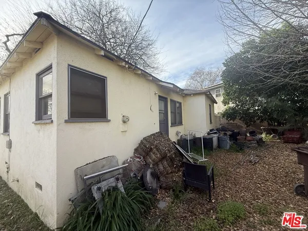 a backyard of a house with outdoor seating