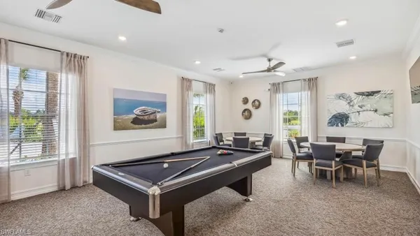 a living room with furniture a large window and a table