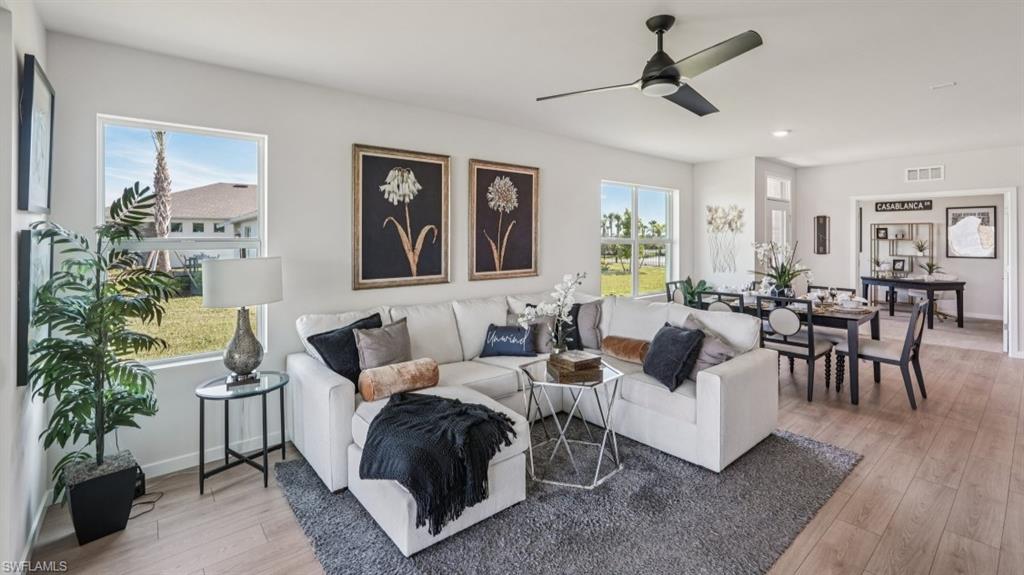 17625 Shade Tree Loop Babcock Ranch, FL 33982 - Photo 5 of 34 a living room with furniture and a potted plant