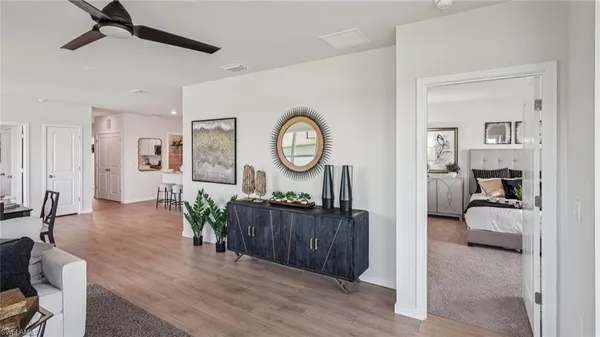 a view of a livingroom with furniture wooden floor a chandelier