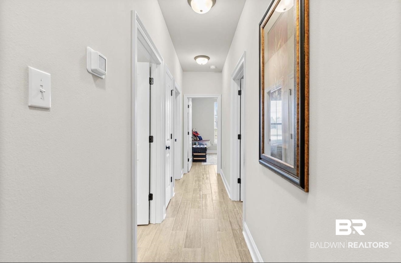 10126 Chipper Lane Foley, AL 36535 - Photo 24 of 30 Hallway featuring light wood-type flooring and baseboards