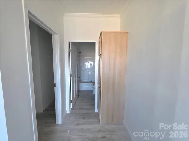 a view of a hallway with two rooms