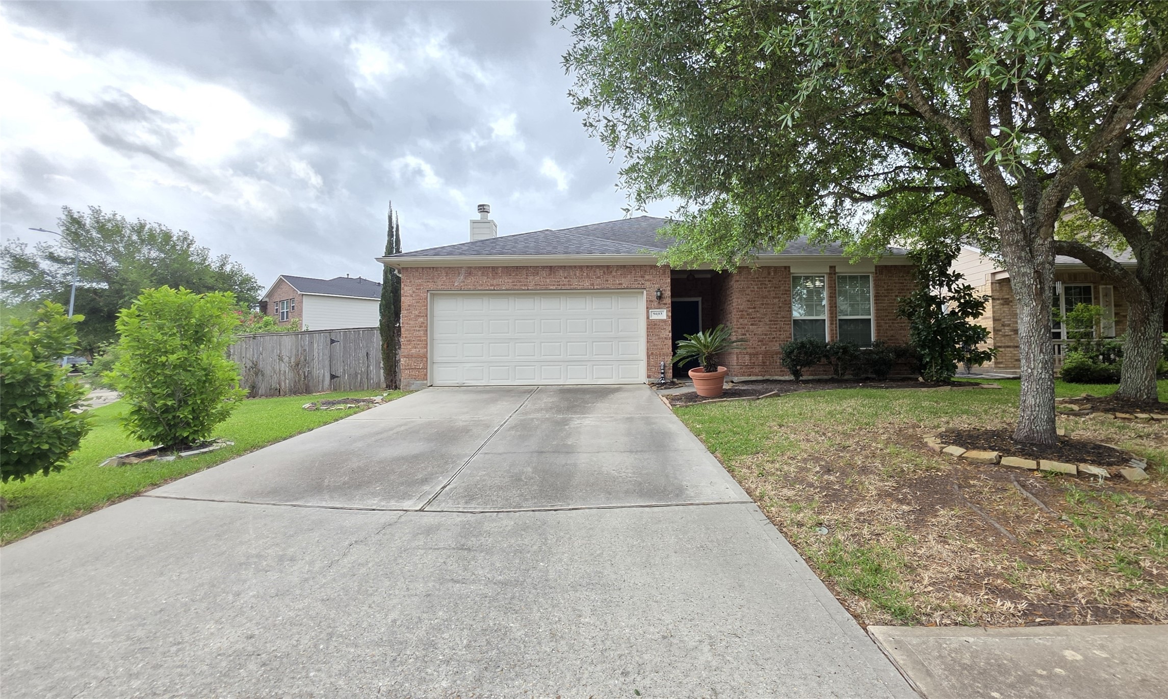 a front view of a house with yard and trees
