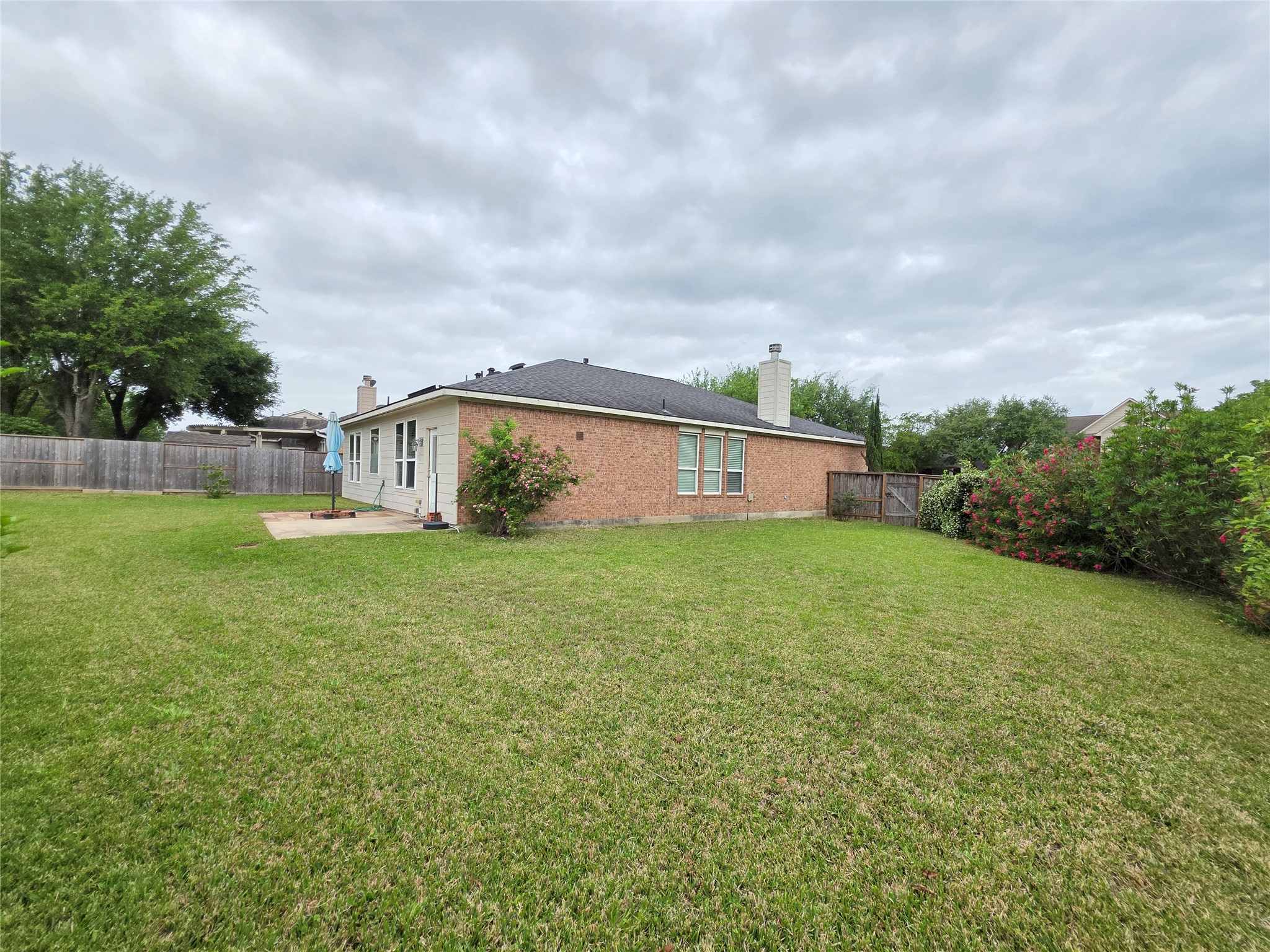 9603 Edgeloch Drive Spring, TX 77379 - Photo 15 of 16 a view of a house with backyard and garden