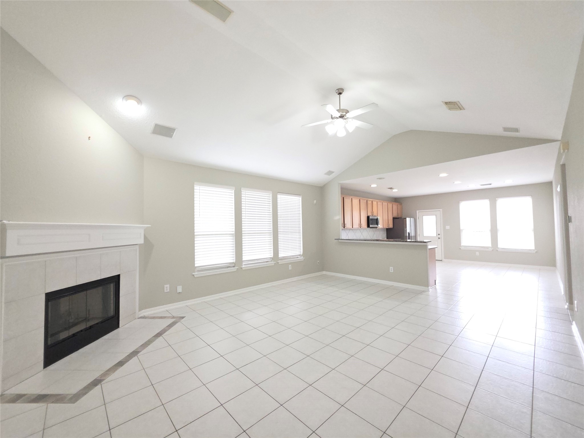 9603 Edgeloch Drive Spring, TX 77379 - Photo 3 of 16 a view of an empty room with a fireplace and a window