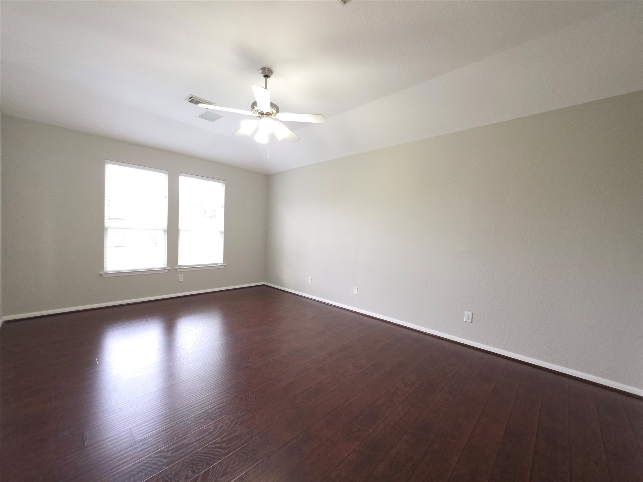 9603 Edgeloch Drive Spring, TX 77379 - Photo 5 of 16 an empty room with wooden floor and windows