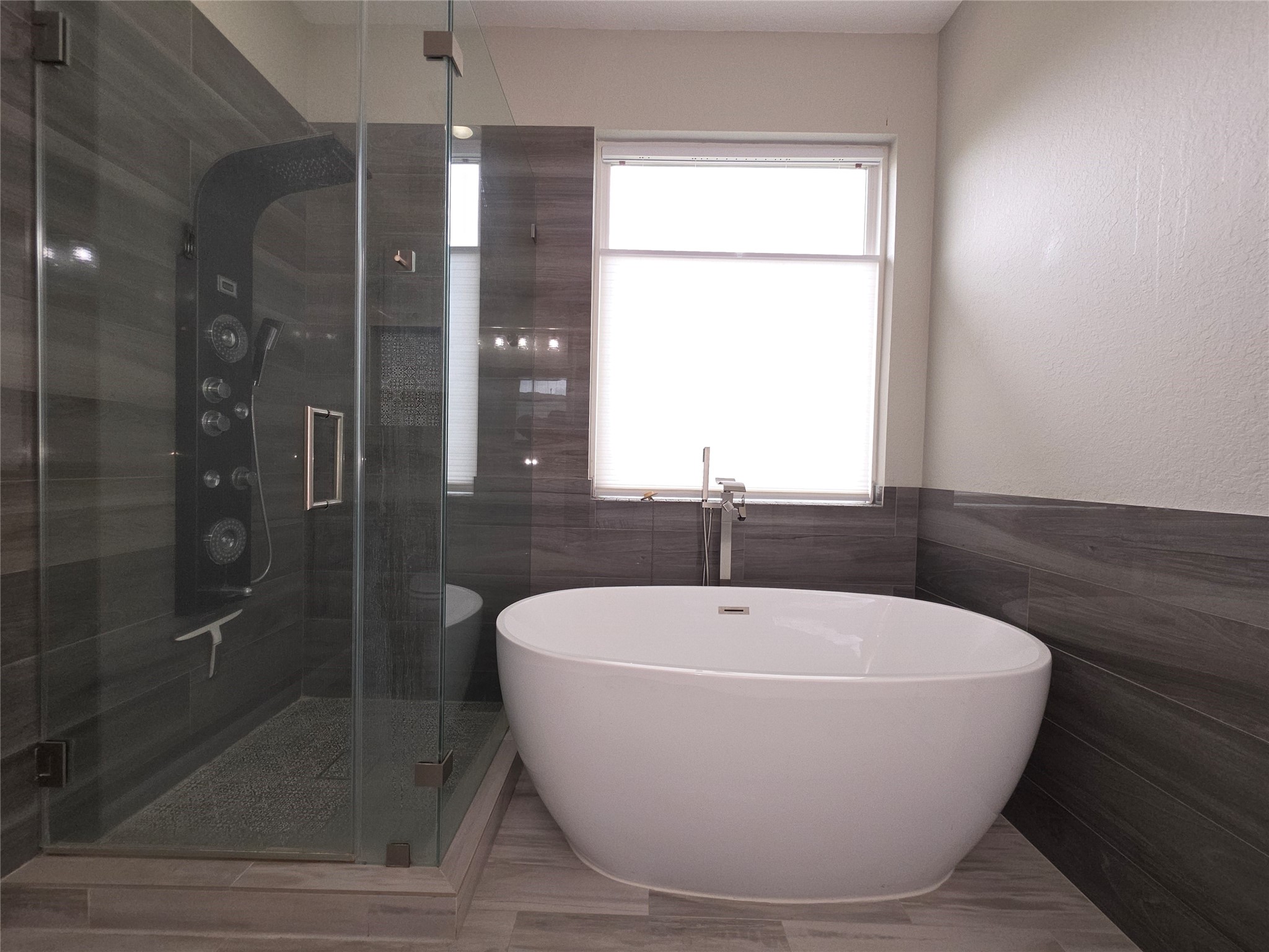 9603 Edgeloch Drive Spring, TX 77379 - Photo 8 of 16 a white bath tub sitting next to a shower