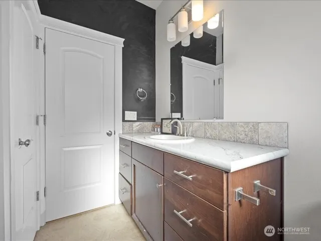 a bathroom with a sink vanity and mirror