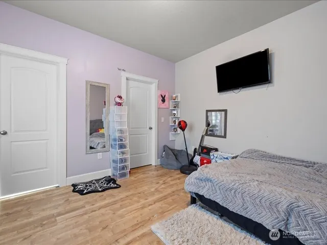 a bedroom with a bed and a flat screen tv