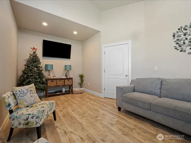 a living room with furniture and a flat screen tv