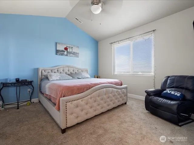 a bedroom with a bed couch and window