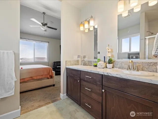 a en suite bathroom with a double vanity sink double and mirror