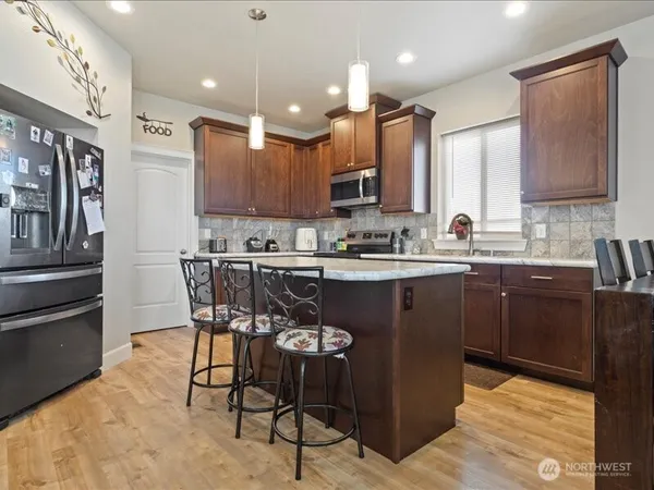 a kitchen with a sink stainless steel appliances and cabinets